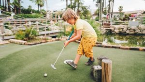 kid playing mini golf in Myrtle Beach